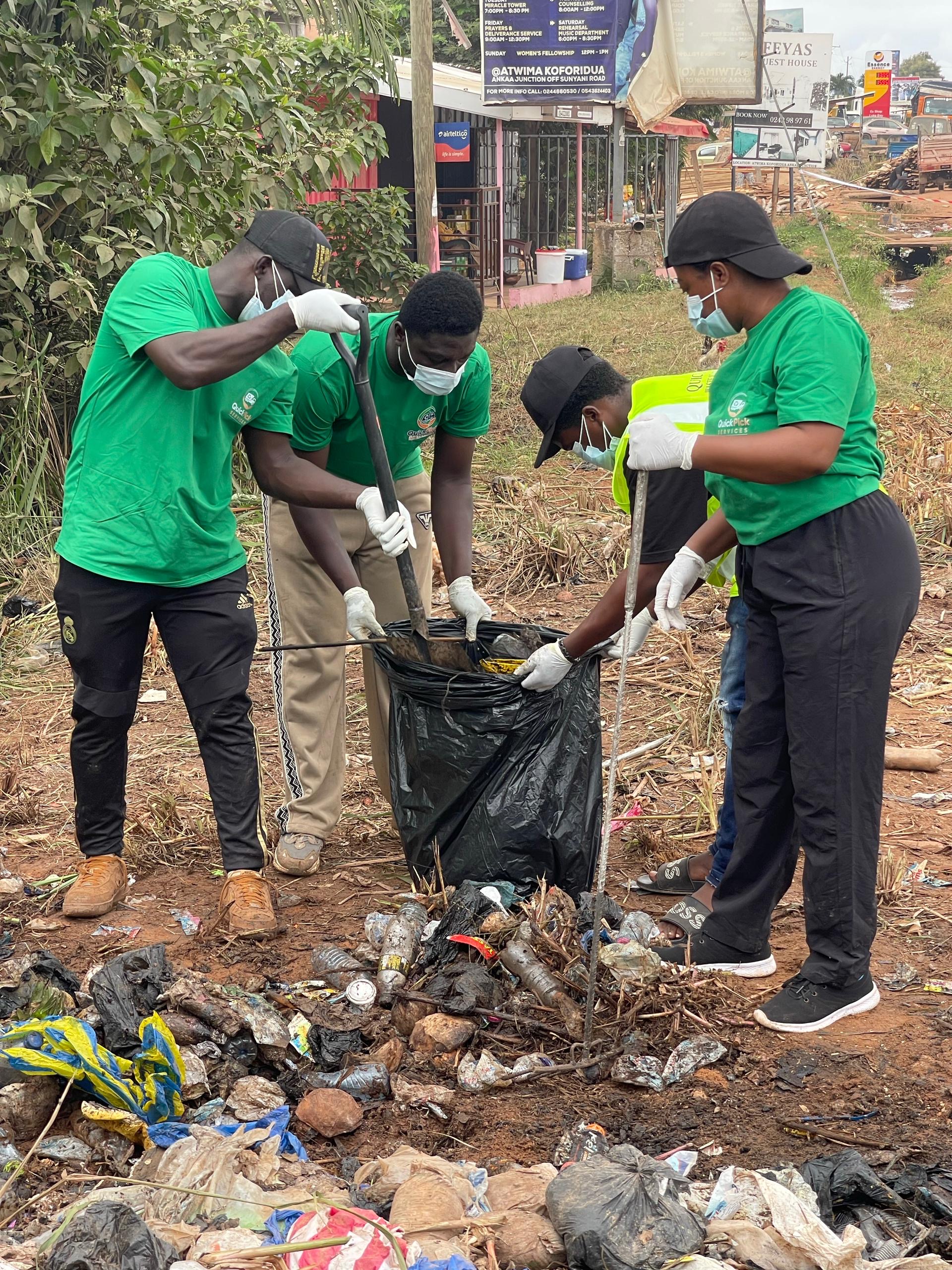 QuickPick team shovelling waste into a bag