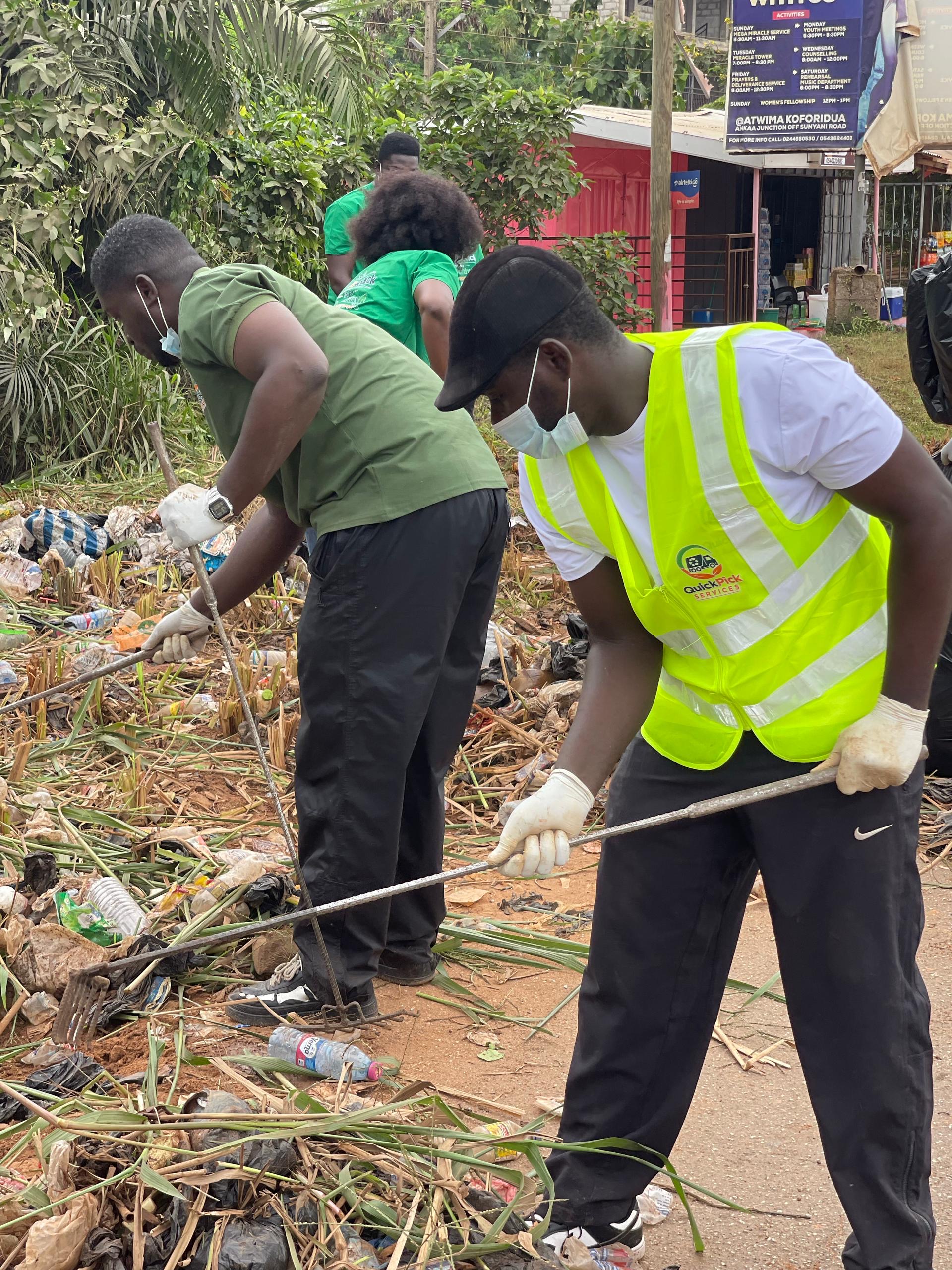 QuickPick worker raking debris during a clean-up